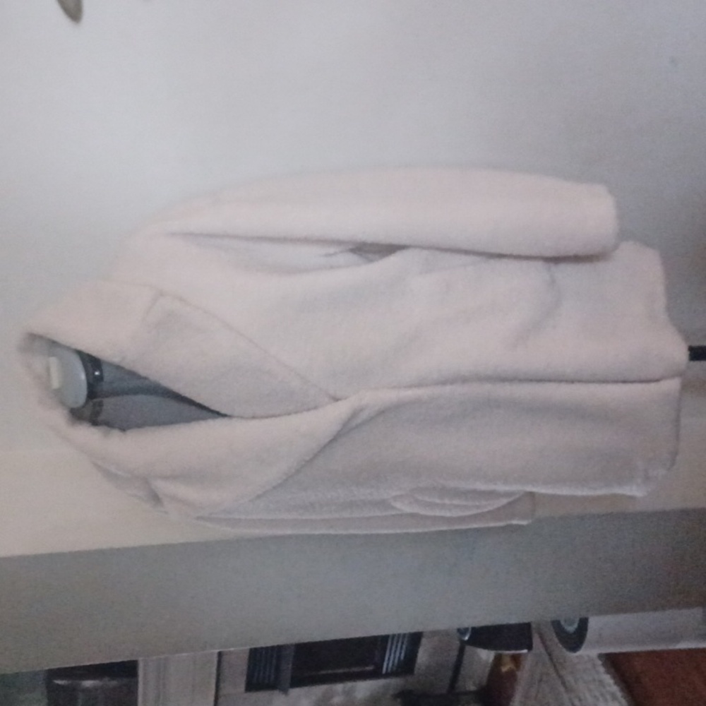Car coat length, cream colored teddy coat.
